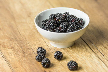 Fototapeta na wymiar Fresh Blackberries Fruits In White Bowl