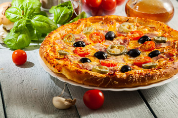 Pizza with bacon, olives and jalapeno pepper