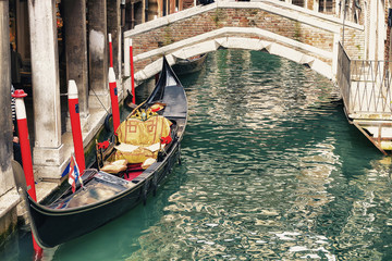 Fototapeta na wymiar Gondola in a little canal in Venice