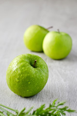 Green apple with drops of water