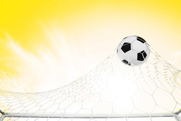 Soccer football in Goal net with Blue sky