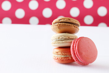 colourful french macaroons on polka dot background