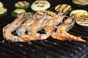 cooking shrimp kebabs on the grill