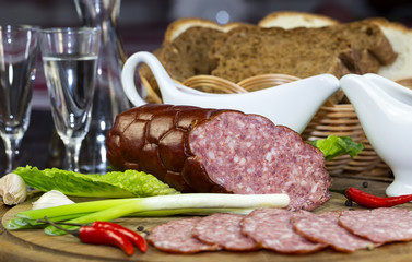 sausages on a wooden plate with vegetables in a restaurant
