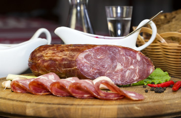 sausages on a wooden plate with vegetables in a restaurant