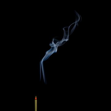 Incense Stick with Smoke on Black Background