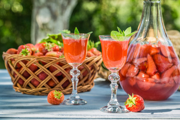 Homemade strawberry liqueur served in the garden