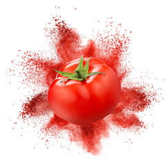 Tomato with red powder explosion isolated on white