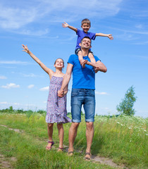 Happy father with kids outdoors against sky