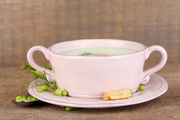 Tasty peas soup on wooden table