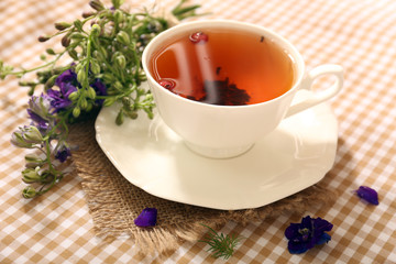 Obraz na płótnie Canvas Cup of fresh herbal tea on table