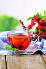 Fruit red tea with wild berries in glass cup,