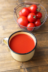 Homemade tomato juice in color mug and fresh tomatoes