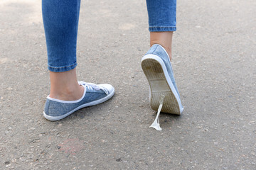 Foot stuck into chewing gum on street