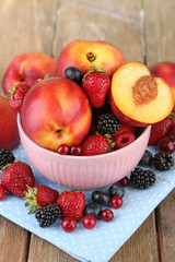 Peaches and berries in bowl on table close-up