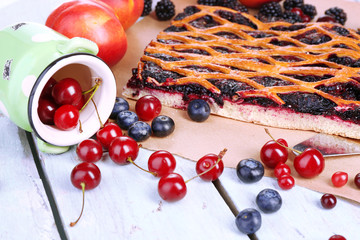 Naklejka na ściany i meble Sweet berries and berry tart on table close-up