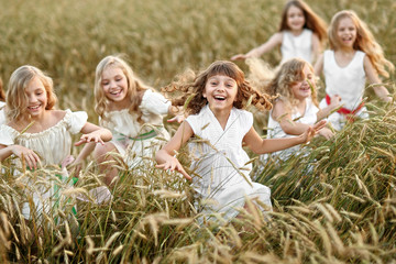 portrait of little girls running on the field