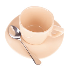 Empty cup with tea spoon isolated on white