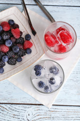 Frozen berries and ice cubes with mint leaves, raspberry and