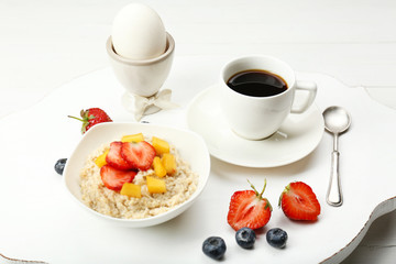 Delicious breakfast with coffee, egg and oatmeal