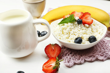 Delicious breakfast with cottage cheese, milk and fruits