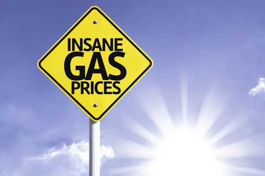 Insane Gas Prices road sign with sun background