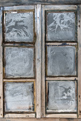 Window of country log house in village on winter