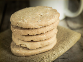 Cookies stack on napkin on wooden table.