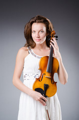 Woman artist with violin in music concept