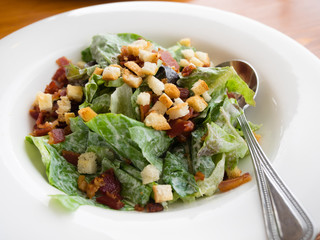Close up ceasar salad in white bowl
