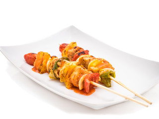 Grilled chicken kebab on skewers isolated on white