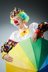Funny clown with colourful umbrella