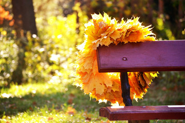 bench and wreath of yellow leaves