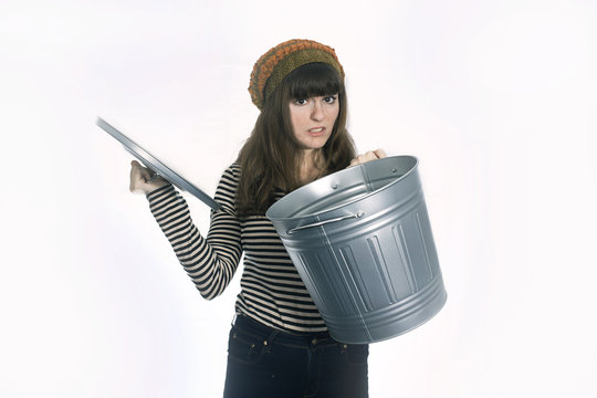 Disgusted Girl Holding Metal  Trash Can