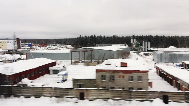 High-speed train is moving close to the warehouse area (POV)