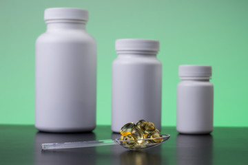 Three supplements bottles with supplements