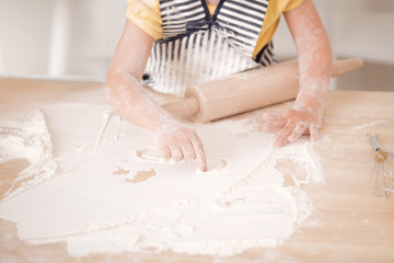 Cute little girl working with rolling pin