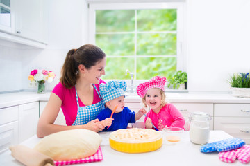 Mother and kids baking a pie