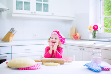 Cute little girl baking a pie