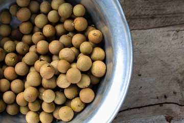 Fresh Longans in a bowl on wood