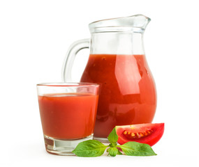 Fototapeta na wymiar Tomato juice in a glass jug with basil