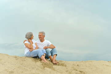 Amusing elderly couple on the beach