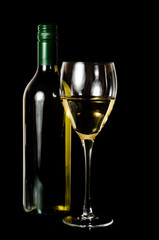 A glass and green rit  bottle of white wine