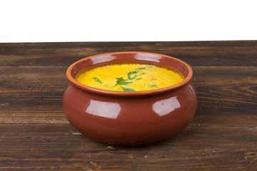 cheese soup in a brown bowl