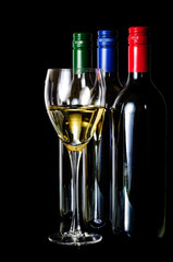 Elegant glass of white wine  and  wine bottle