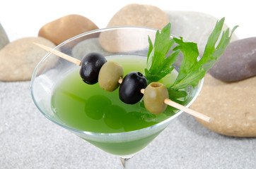 Cherry cocktail in a environment of sand and pebble stones