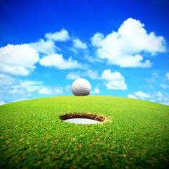 golf ball and hole on a field