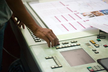 Printer checking a print run at table