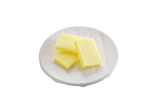 cheese in ceramic dish on white background