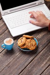 Cookie and women hand with notebook.
